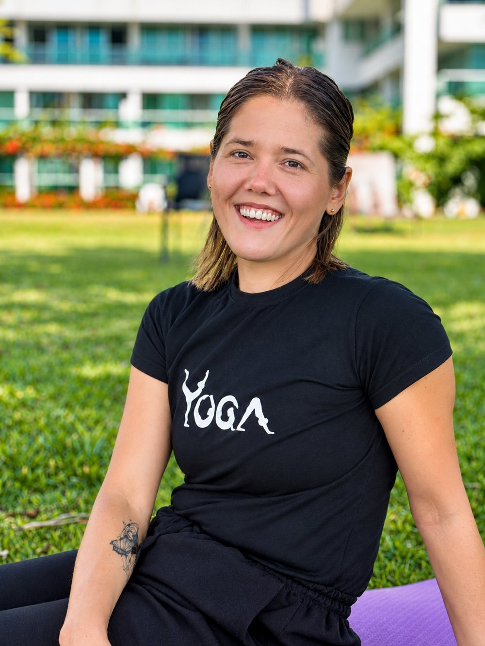 Jhennyfer Kali sorrindo, com a mão na cintura